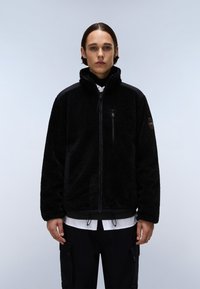 Μαύρο φλις μπουφάν με υψηλό γιακά, κλείσιμο με φερμουάρ και πλάγιες τσέπες. Διαθέτει υφή στην επιφάνεια και αντιθετικές μαύρες υφασμάτινες λεπτομέρειες.