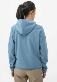 Blue fleece hoodie with a relaxed fit, hood, and long sleeves. Soft texture, plain design, and a slightly curved hem.