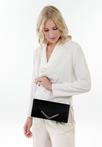 Black rectangular clutch bag with a textured finish, silver chain strap, and a sleek metallic detail on the front.