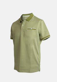 Polo de manga corta en verde oliva, con tejido texturizado, y acentos blancos contrastantes en el cuello y el bolsillo del pecho, con dos botones.