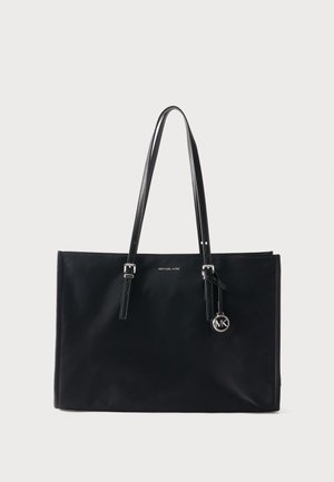 Black rectangular tote bag with double shoulder straps, silver buckles, and circular MK logo charm hanging from one strap.