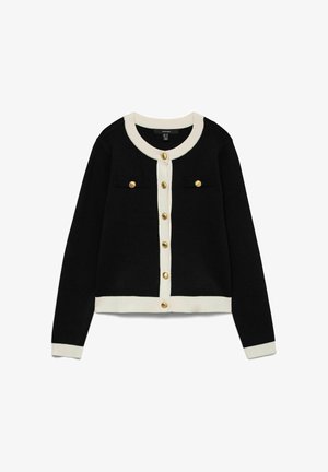 Cardigan noir avec des finitions blanches sur le col, les poignets et l'ourlet, avec des boutons dorés sur le devant et sur deux poches poitrine.