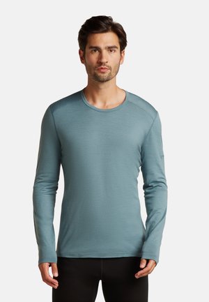 Hellblause Langarmshirt aus weichem Stoff, mit rundem Hals, flachen Nähten und taillierter Passform. Geeignet für Freizeitkleidung.