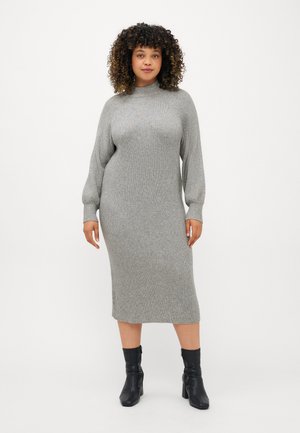 Ribbed knit dress in light gray with a high neck, long sleeves, and a mid-length silhouette, paired with black ankle boots.