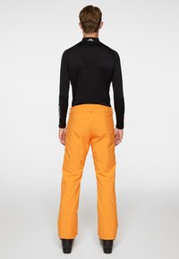 J.LINDEBERG Sports CLARKE - Pantaloni da sci - persimmon orange
