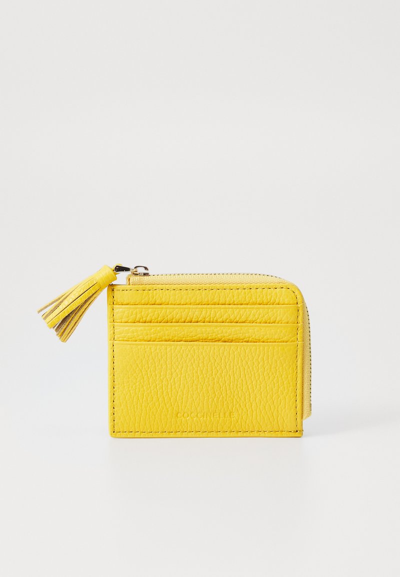 Yellow leather wallet with a textured finish, featuring a zipper closure and a tassel detail, plus multiple card slots on the front.