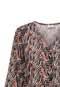 Mehrfarbige Bluse mit V-Ausschnitt, schwarzen und rostfarbenen wellenförmigen Mustern auf einem cremigen Grund, mit subtilen Knopfdetails und weichem Stoffgefühl.