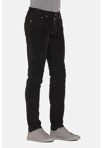 Jeans neri in cotone, con vestibilità slim, tasche frontali, zip e chiusura a bottone, dalla texture liscia e con pochi dettagli in metallo.