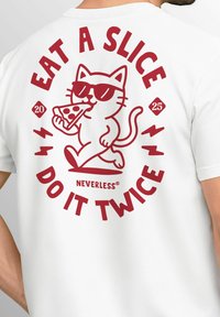 White t-shirt featuring a cartoon cat with sunglasses, holding a slice of pizza. Red text reads "EAT A SLICE DO IT TWICE" with decorative accents.