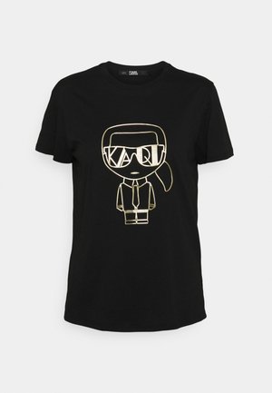 T-shirt noir à manches courtes avec un motif contour doré représentant une personne portant des lunettes de soleil, une cravate et une queue de cheval à l'avant.