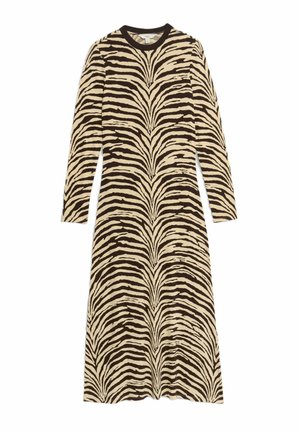 Robe à manches longues en crème avec de larges rayures zèbres noires, encolure ronde et silhouette évasée, réalisée dans un tissu doux et texturé.