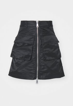 Black skirt made of shiny fabric, featuring a centered zipper and two large front pockets with flaps. Simple, clean design.