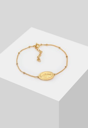 Gold chain bracelet featuring an oval medallion with an engraved design, delicate links, and a lobster clasp with adjustable chain.