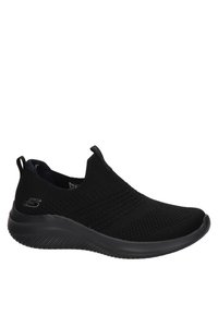 Baskets noires sans lacets avec empeigne en maille texturée, semelle souple et languette au talon, conçues pour un usage décontracté ou sportif.