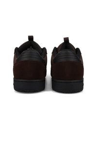 Ein Paar dunkelbraune und schwarze Sneaker von hinten gezeigt, mit gepolsterten Kragen und Zuglaschen auf weißem Hintergrund.