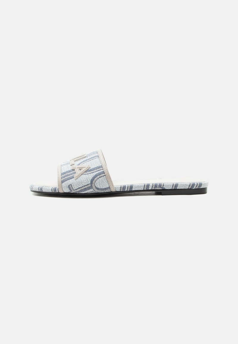 Sandale plate à enfiler avec bride et semelle en tissu bleu et blanc à motifs, avec une bordure beige et une semelle extérieure plate noire.