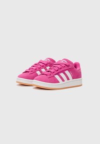 Pink suede sneakers with white stripes, lace-up design, padded collar, and rubber outsole. Features a rounded toe and simple branding.