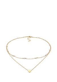 Gouden gelaagde ketting met kleine witte parels, met een hartvormige hanger als centraal punt. Gepolijste afwerking en delicate kettingen accentueren het ontwerp.