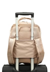 Beige fabric backpack attached to a black wheeled suitcase, featuring mesh accents and adjustable straps, with a retractable handle.