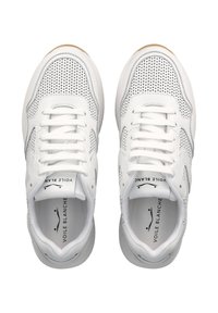 White sneakers made of leather and mesh, featuring a perforated design, flat laces, and a rubber sole with a beige accent.