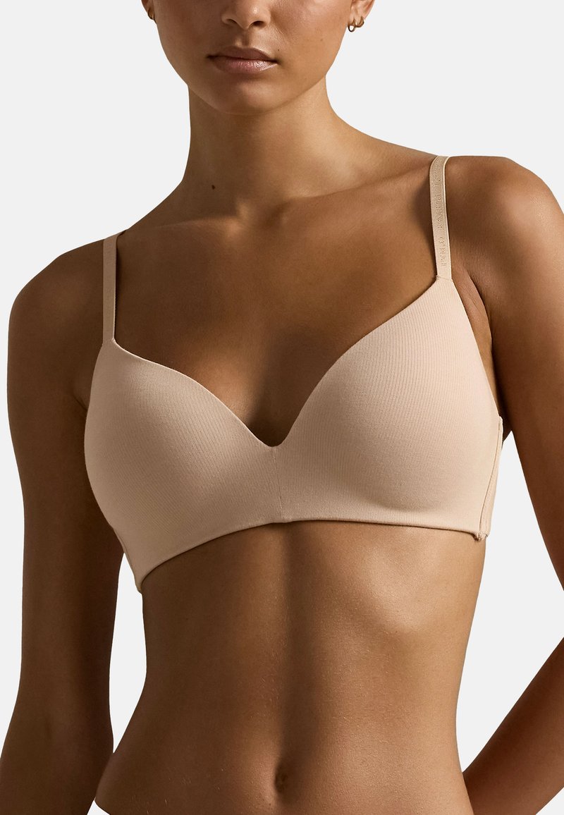 Reggiseno beige senza cuciture con spalline regolabili, scollatura profonda e morbida texture a coste. Design semplice, adatto per l'uso quotidiano.