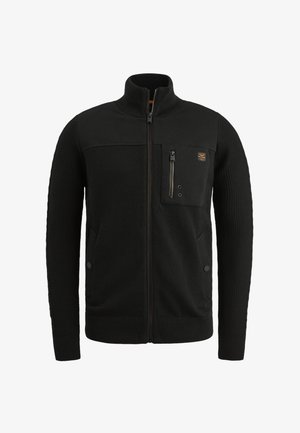 Chaqueta negra con cremallera y cuello alto, mangas texturizadas, bolsillo frontal con cremallera y dos bolsillos laterales. Fabricada con un material suave y de punto.