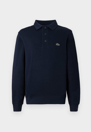 Navy blue long-sleeve polo shirt with button placket and small green crocodile logo on the chest.