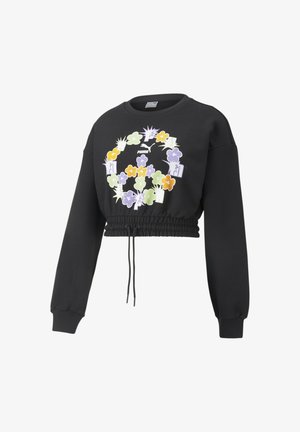 Sweatshirt noire raccourcie avec taille élastique, manches longues et graphique coloré d'un signe de paix floral avec le logo Puma sur la poitrine.