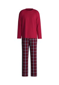 Rode lange mouwen top gecombineerd met een geruite broek in rood, blauw en wit. De top heeft een ronde halslijn; de broek heeft een elastische tailleband.