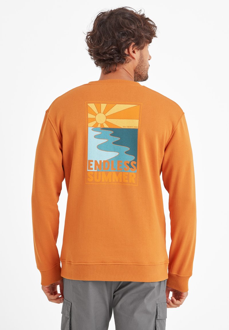 Orange sweatshirt with long sleeves, featuring a graphic print of a sun, river, and text "ENDLESS SUMMER" in bright colors on the back.