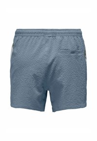 Blue textured swim shorts with elastic waistband, two side pockets, and a rear pocket. Material features a subtle, crinkled pattern.