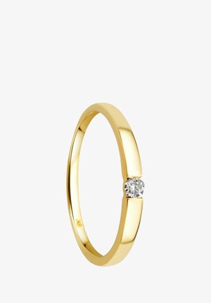 Bague en or avec un bandeau poli et un accent de diamant rond central. Le design est épuré, lisse et de style minimaliste.