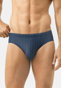 Short de bain bleu en tissu extensible, avec un motif circulaire répété, une texture lisse et une coupe taille moyenne.