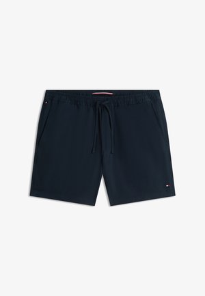 Marineblauwe zwembroek met elastische tailleband, trekkoord, zijzakken en klein Tommy Hilfiger-logo op het linkerbeen en de tailleband.