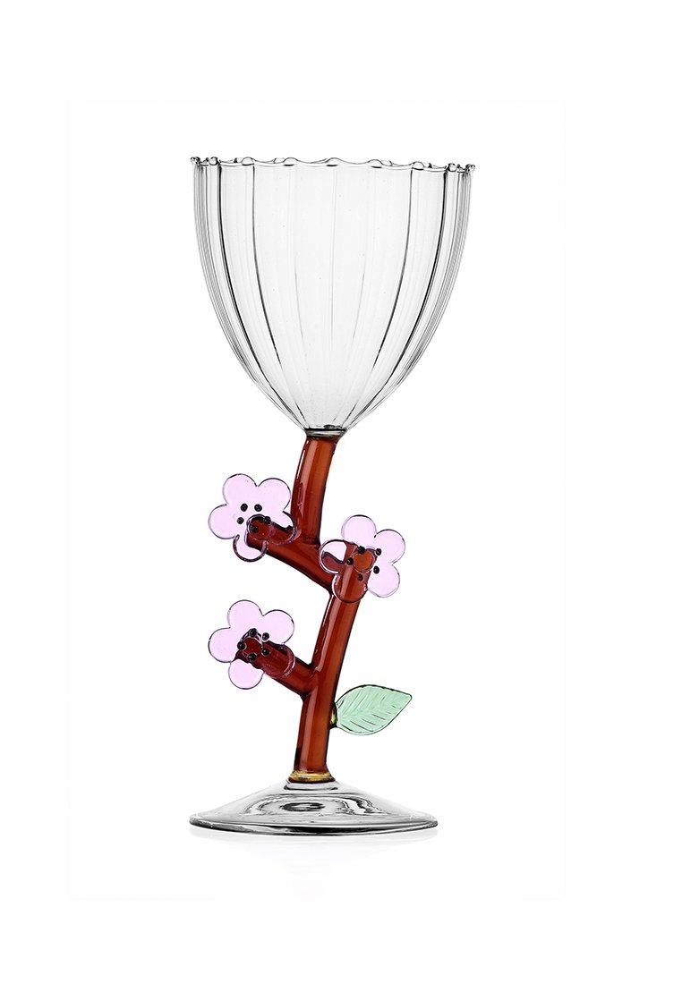 Przezroczysty kieliszek do wina z żebrowanym kielichem, brązowym trzonkiem przypominającym gałęzie, ozdobiony różowymi kwiatami oraz zielonym liściem u podstawy.