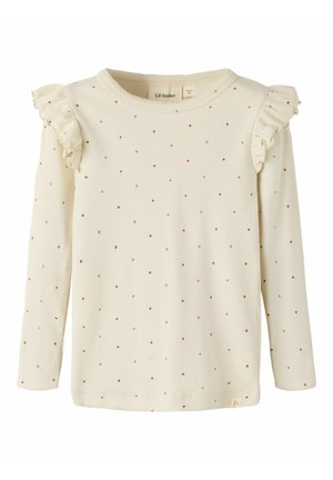 Chemise crème à manches longues en tissu côtelé avec petits pois roses et détails volantés sur les coutures d'épaule pour enfants.