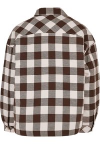 Chemise à carreaux marron et blanc à manches longues avec col large vue de dos, présentant un grand motif à carreaux Buffalo.