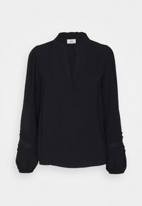 Blusa nera a maniche lunghe con collo alto, caratterizzata da maniche plissettate e scollatura a fessura. Tessuto morbido e testurizzato con dettagli arricciati ai polsini.