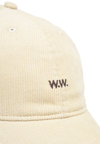 Beige kordbársony sapka ívelt karimával, brown hímzett "W.W." kezdőbetűkkel és finom textúrával a bordázott anyagból.