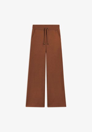 Pantalons amples marron en matériau doux, dotés d'une taille élastique avec cordon de serrage et de deux poches à l'avant.