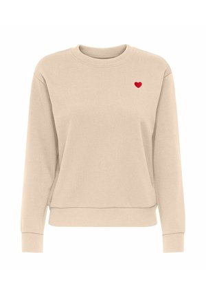 Sweat-shirt beige à col rond avec des manches longues et un petit cœur rouge brodé sur le côté gauche de la poitrine.