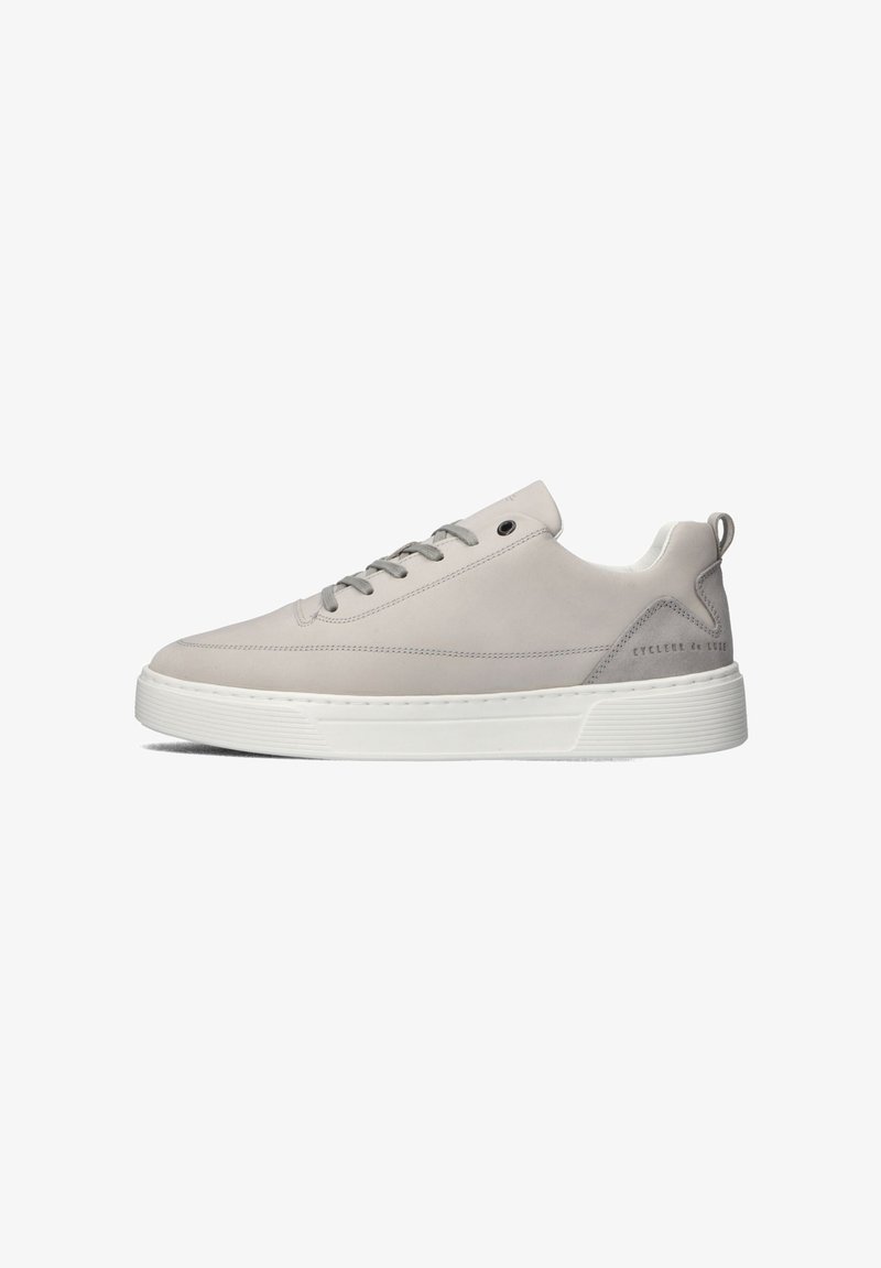Light gray leather sneaker with round toe, flat white sole, gray laces, and subtle branding on the heel. Features textured accents.