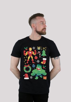 Black T-shirt featuring colorful cartoon graphics of Iron Man and Hulk, Christmas decorations, and festive patterns in a playful design.