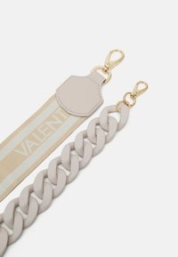 Light beige strap with "VALENT" logo and gold hardware, paired with a thick chain in a matching shade. Smooth texture, minimal design.
