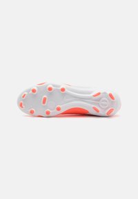White athletic shoe sole with pink accents. Features rounded studs for traction and a smooth textured surface. Streamlined design.