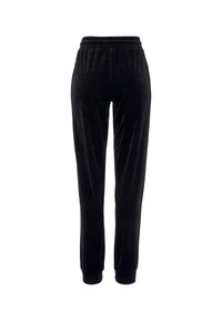 Schwarze Velours-Sweatpants mit elastischem Bund, slim-fit Design und gerippten Bündchen an den Knöcheln. Weiche, glatte Textur.