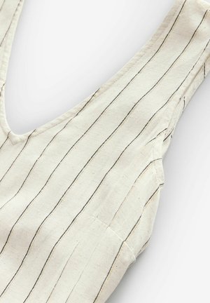 Haut sans manches de couleur crème avec des rayures verticales noires et dorées, un décolleté plongeant et un tissu texturé. Design simple sans ornements.
