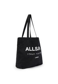 Black canvas tote bag with long handles, featuring bold white text "ALLSAINTS" and additional text in Japanese, branded "LONDON."