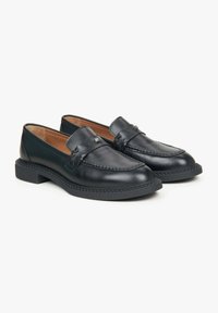 Black leather loafers with a smooth finish, decorative stitching, and a woven accent on the strap. Features a low, sturdy sole.
