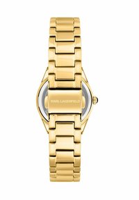 Orologio in metallo dorato con finitura liscia e lucida. Design con bracciale a maglie solide e cassa rotonda, con logo del marchio sulla fibbia.